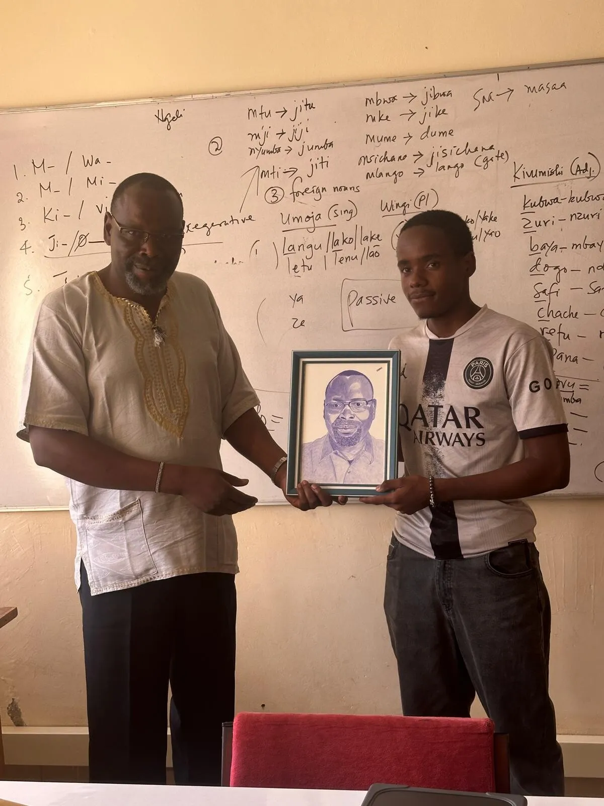 Handing a finished, framed portrait to the person it was made for